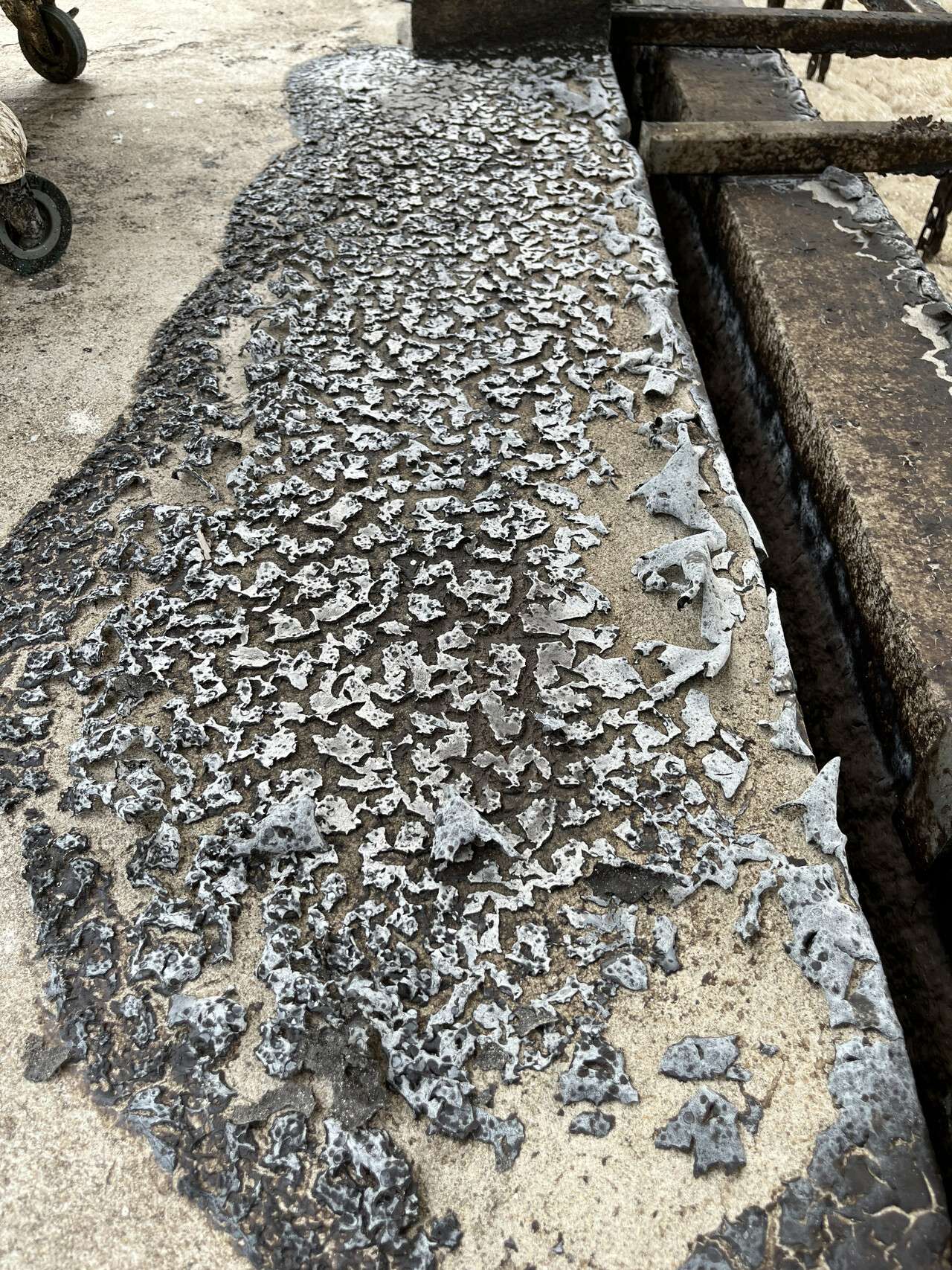 Dried MBR foam deposits on a tank walkway after overflow
