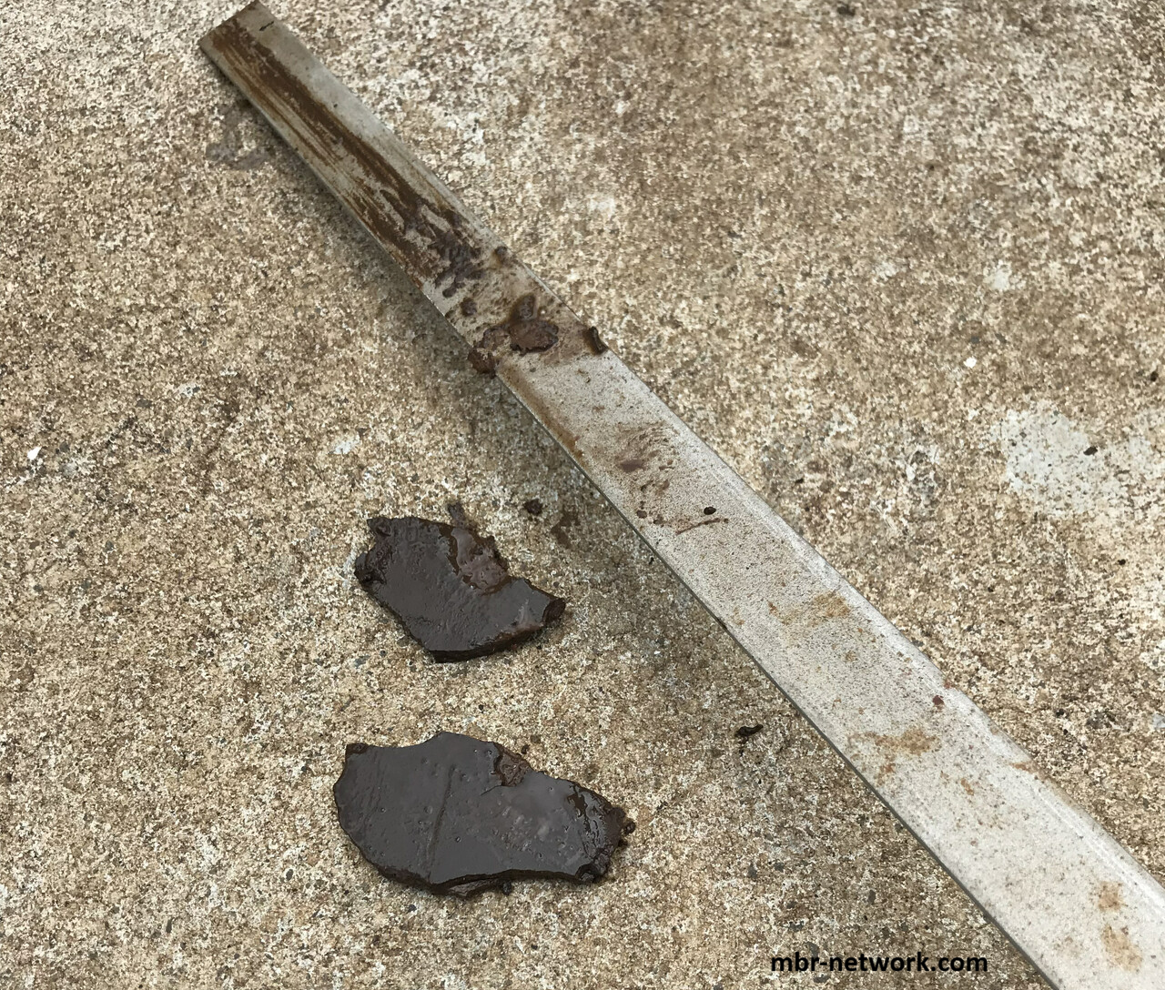 Dried and hardened sludge removed from between MBR membrane sheets