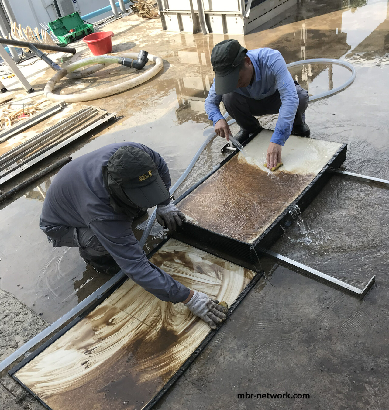 Manual scrubbing of removed MBR membrane plates during physical cleaning